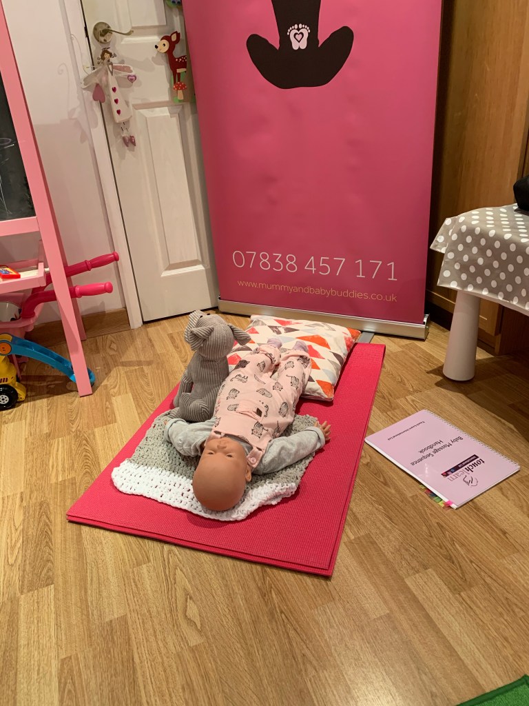 A photo showing my online class setup with massage doll