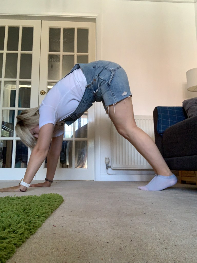 A photo demonstrating downward dog yoga pose