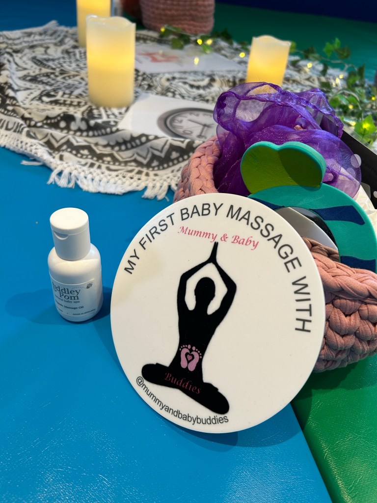 A picture showing a “my first massage” photo prop and a bottle of massage oil